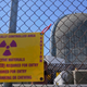 A sign warning of radioactive materials is seen on a fence around a containment building at Indian Point Nuclear Power Plant.